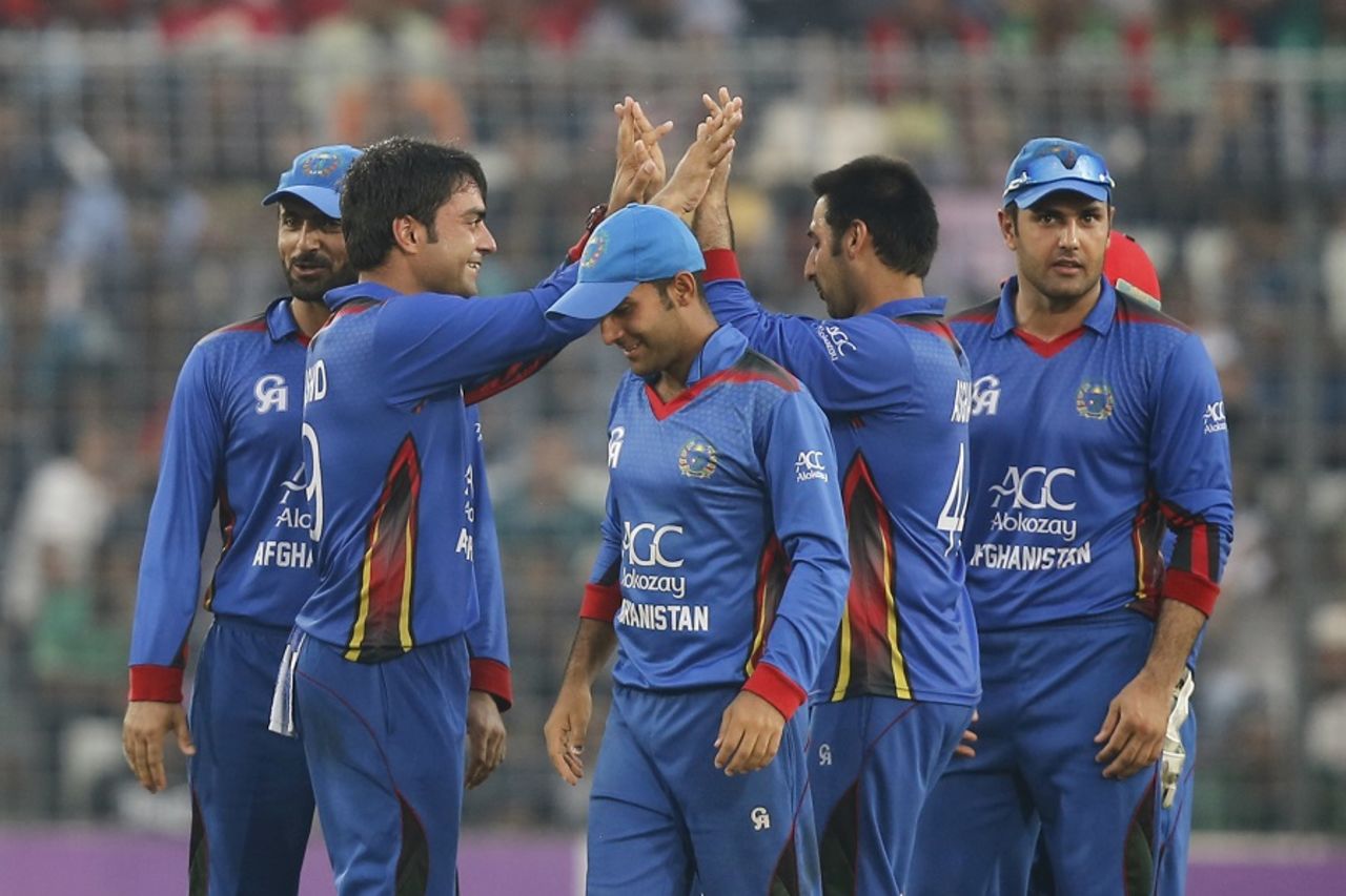 Rashid Khan is mobbed by his team-mates, Bangladesh v Afghanistan, 2nd ODI, Mirpur, September 28, 2016