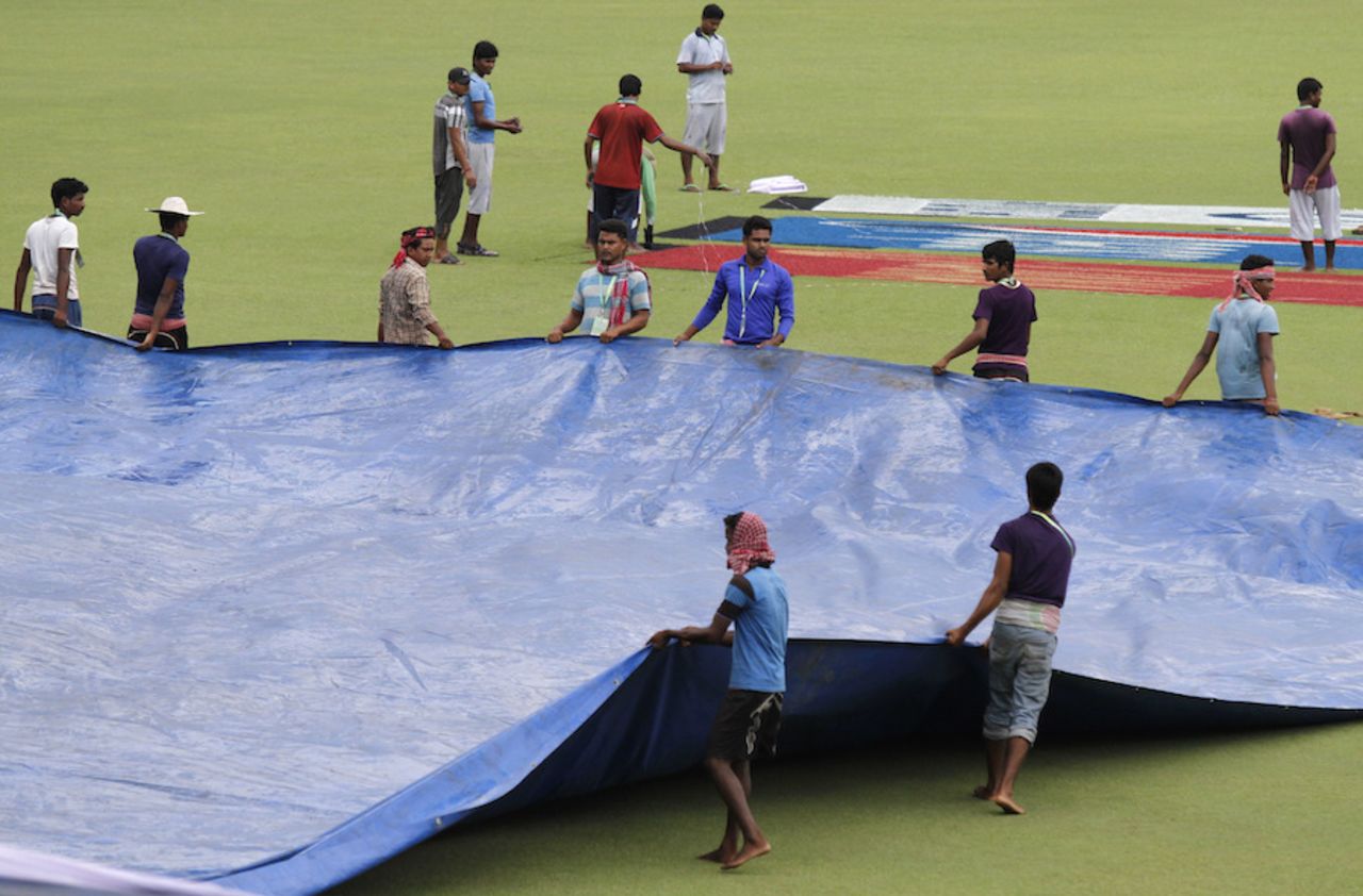 Groundsmen cover the field at Eden Gardens a day before the second Test, Kolkata, September 29, 2016
