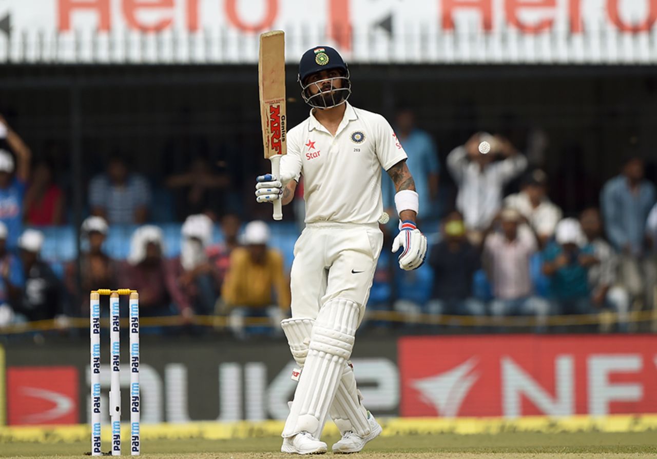 Virat Kohli raises his bat after scoring a half-century, India v New Zealand, 3rd Test, Indore, 1st day, October 8, 2016