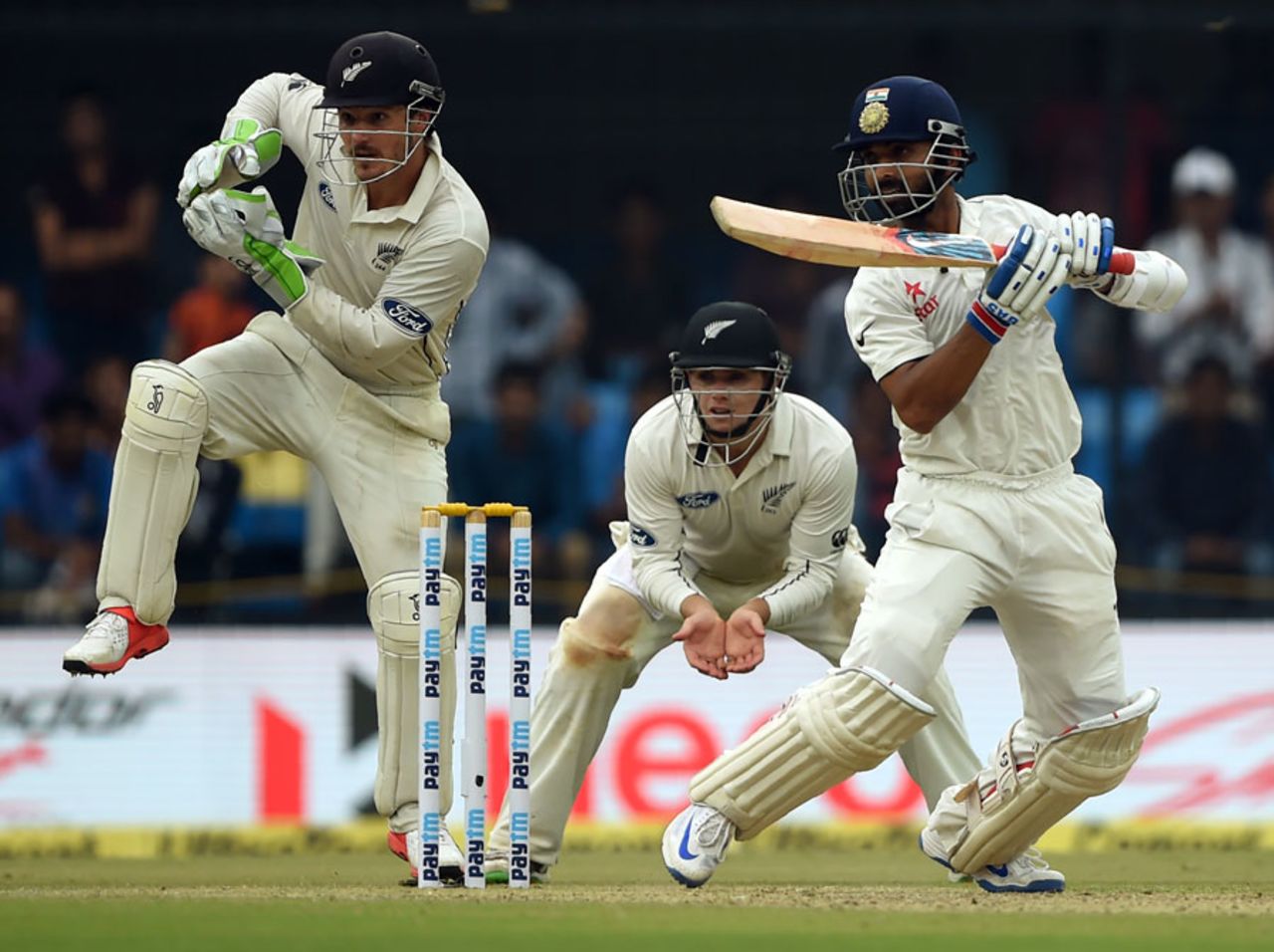 BJ Watling and Tom Latham look on as Ajinkya Rahane punches through the off side, India v New Zealand, 3rd Test, Indore, 1st day, October 8, 2016