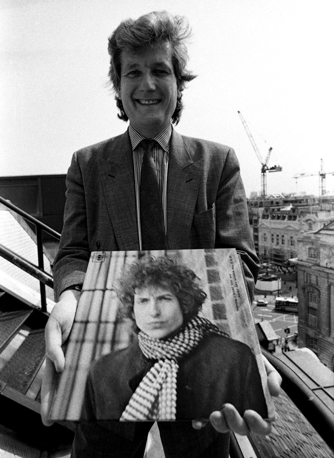 Bob Willis holds an album of Bob Dylan, 1990