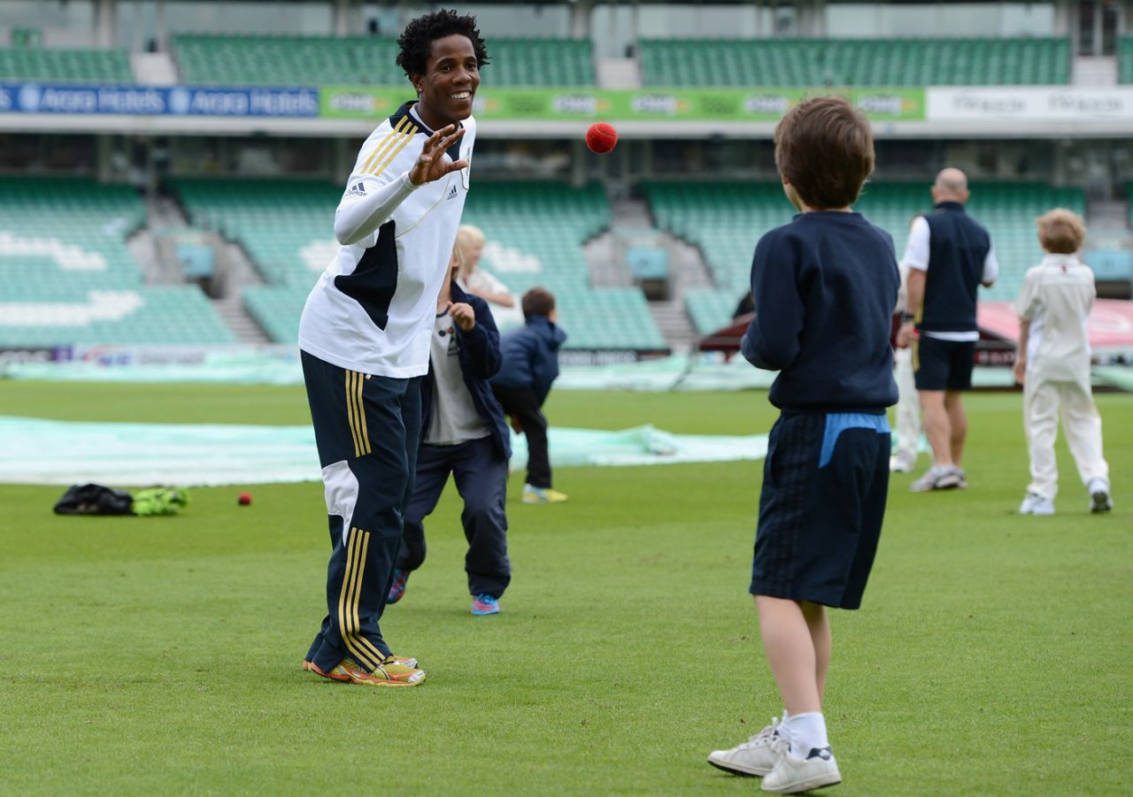 Thami Tsolekile plays local school children during a coaching clinic in aid of Nelson Mandela Day, The Oval, London, July 18, 2012