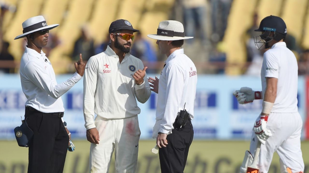 Virat Kohli and the umpires have a chat after Umesh Yadav's catch is referred to the third umpire, India v England, 1st Test, Rajkot, 1st day, November 9, 2016