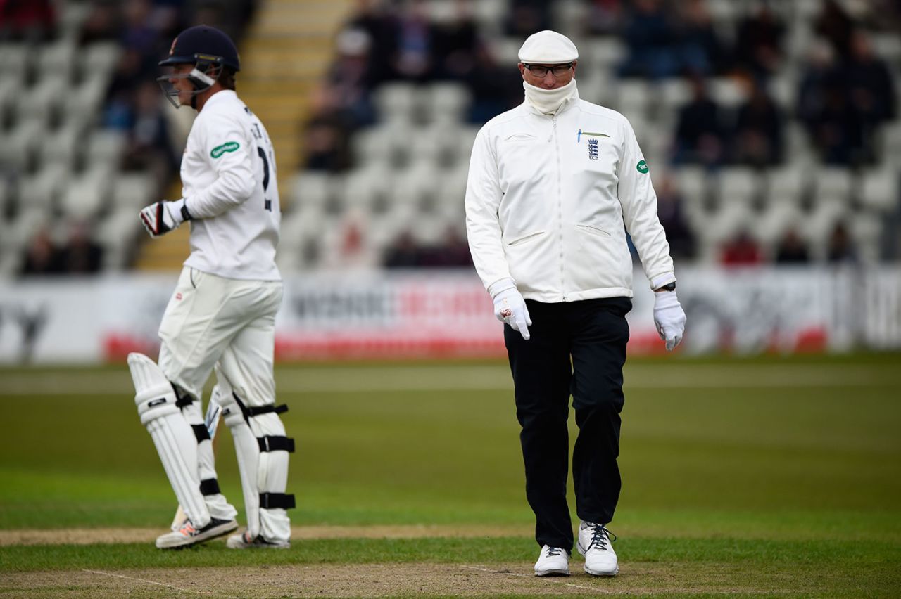 Umpire Neil Mallender feels the cold, Worcestershire v Essex, County Championship, Division Two, New Road, 2nd day, May 2, 2016