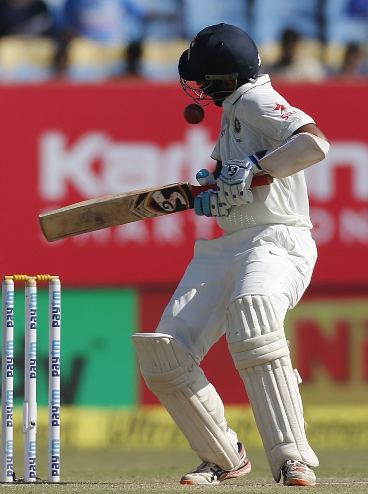 A short ball rattles Cheteshwar Pujara's helmet, India v England, 1st Test, Rajkot, 3rd day, November 11, 2016