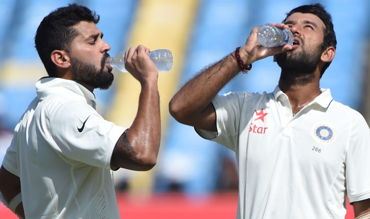 M Vijay and Cheteshwar Pujara rehydrate during the drinks break, India v England, 1st Test, Rajkot, 3rd day, November 11, 2016