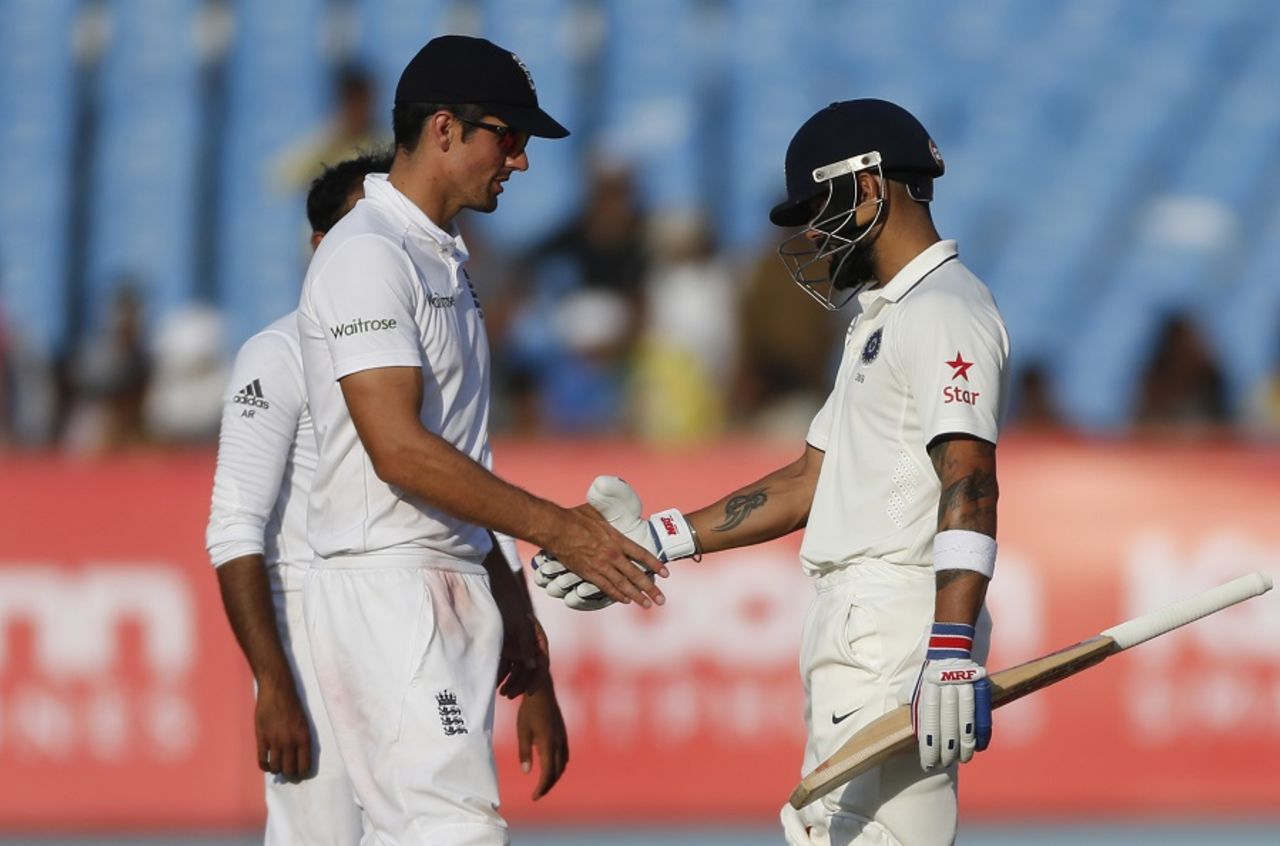 Virat Kohli and Alastair Cook shake hands to signal the end of the match, India v England, 1st Test, Rajkot, 5th day, November 13, 2016