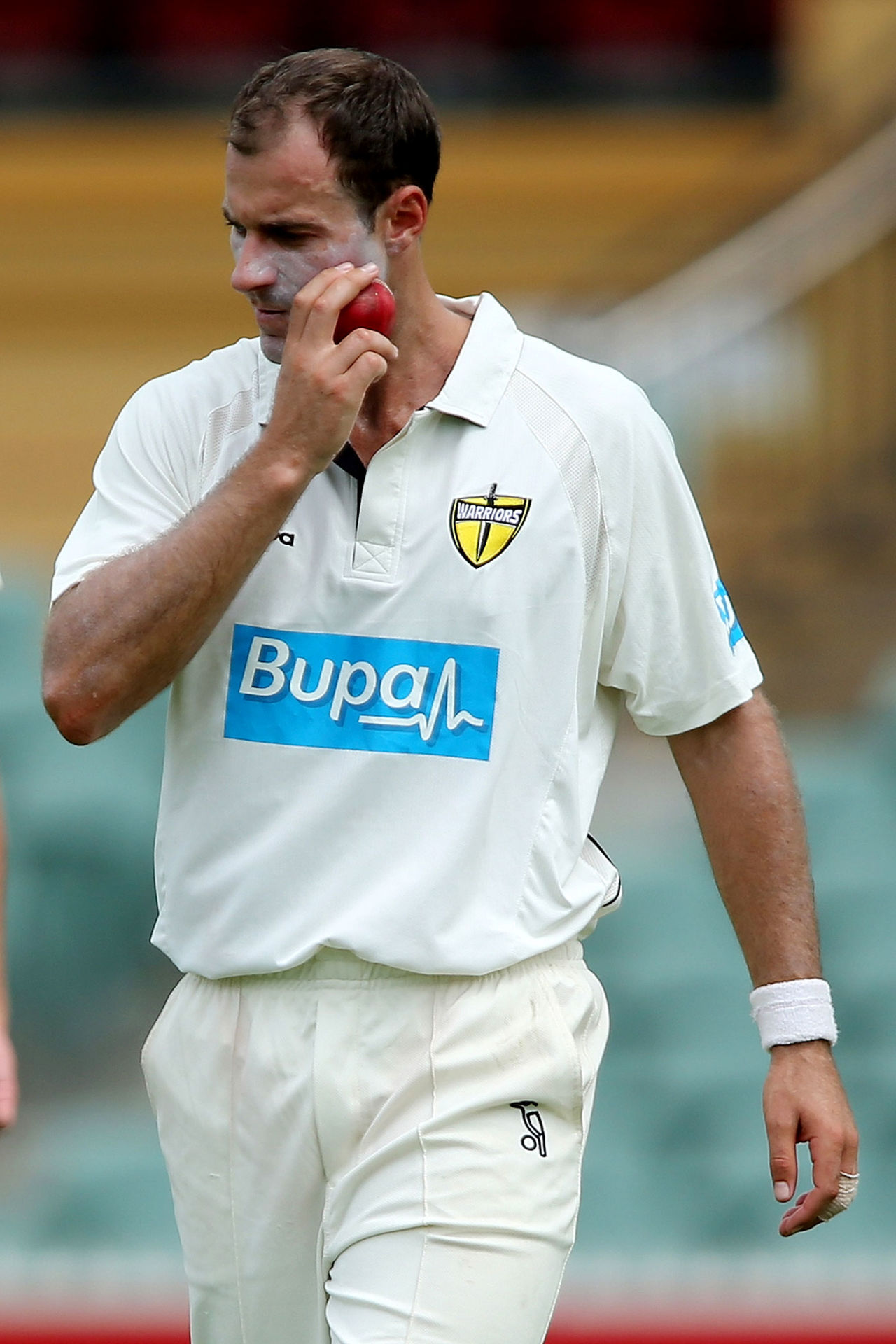 Burt Cockley appears to be rubbing the ball on his face, Sheffield Shield, South Australia v Western Australia, Adelaide, 1st day, March 7, 2013