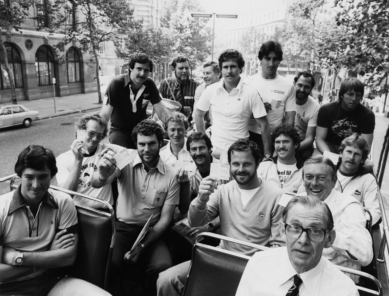 The Australian player show their complimentary bus passes on a double-decker tourist bus in London, August 26, 1980