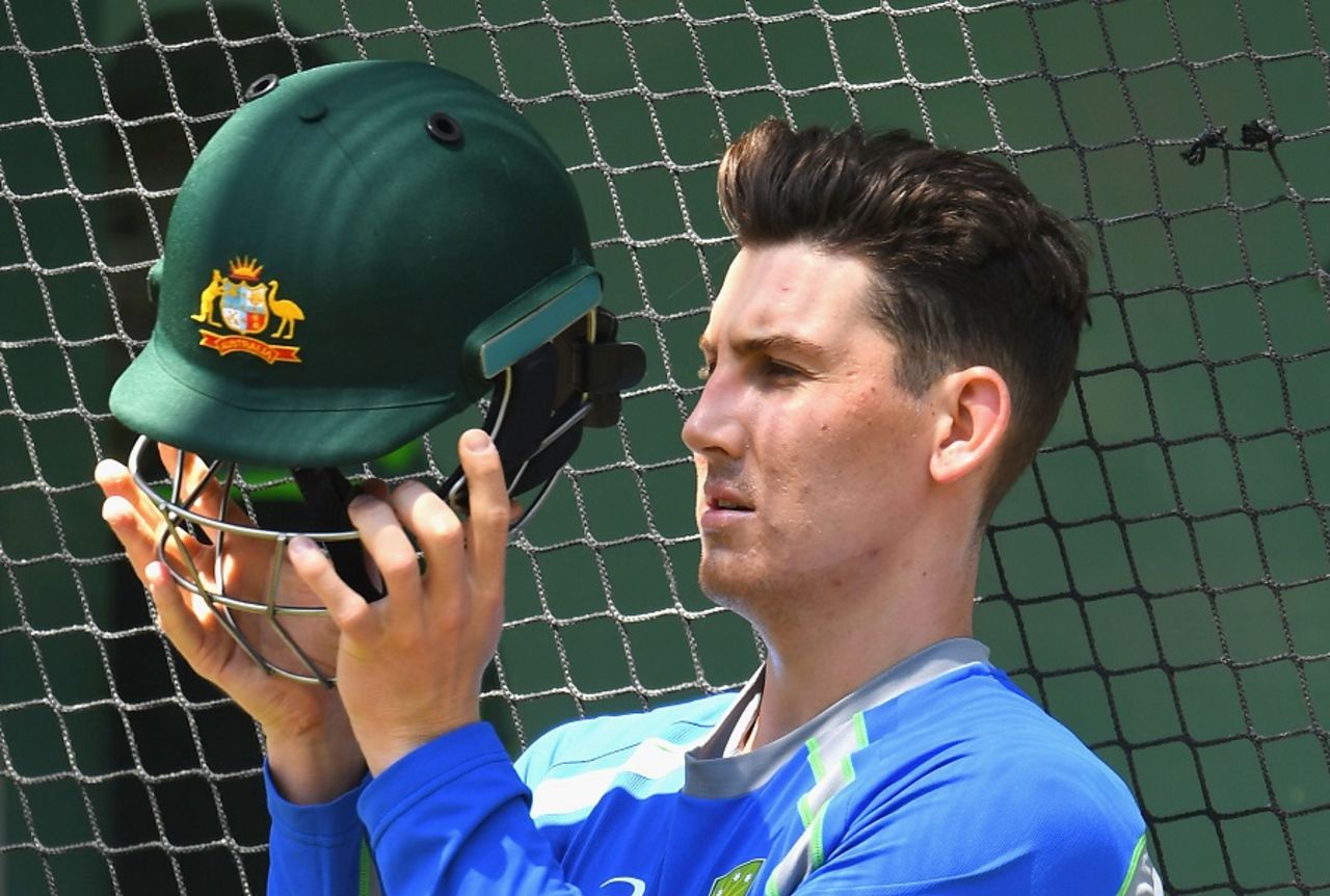 Nic Maddinson checks out his helmet during training, Melbourne, December 23, 2016