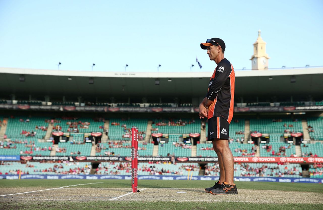 Scorchers coach Justin Langer inspects the pitch before the start of the game, Sydney Sixers v Perth Scorchers, Big Bash League, Sydney, December 27, 2016