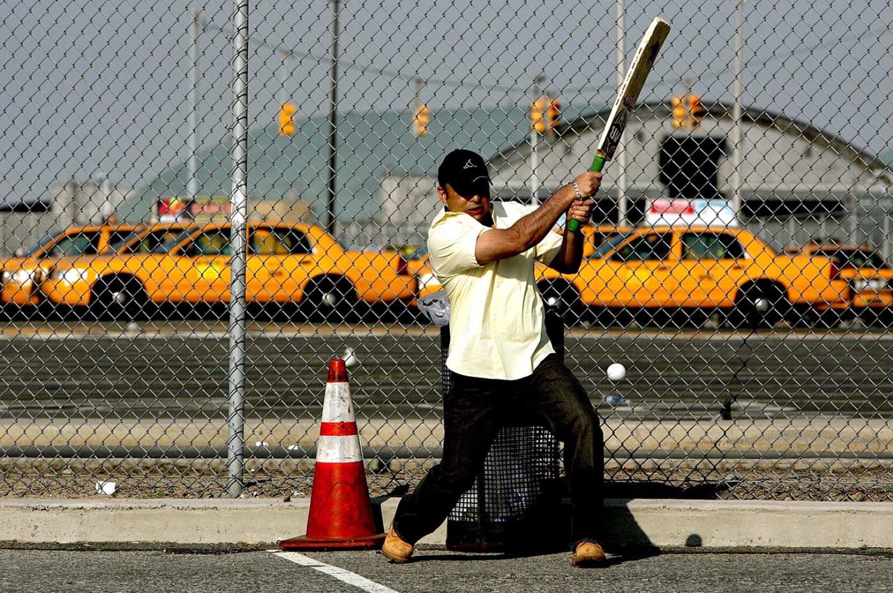 A taxi driver bats in a taxi holding area next to John F Kennedy Airport, New York City, May 6, 2006