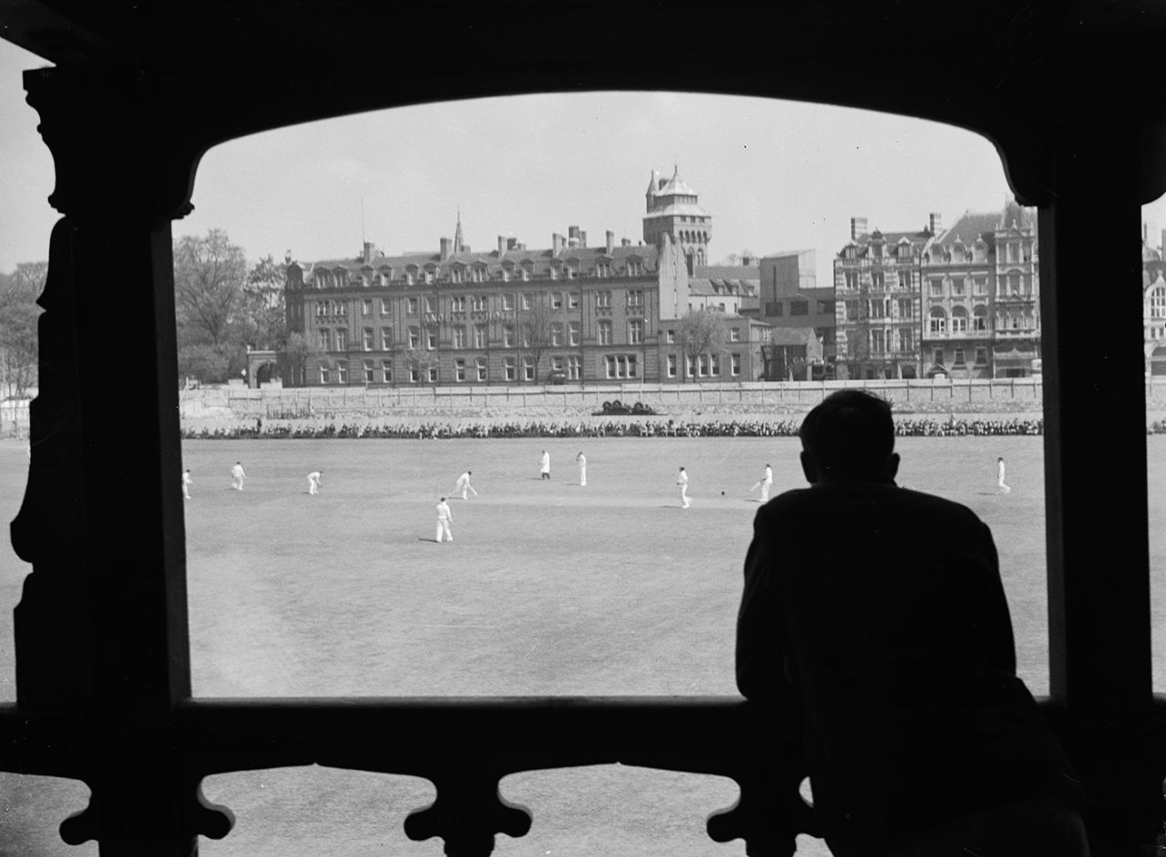 A man leans on the pavilion rails to watch cricket, Cardiff, May 1936  