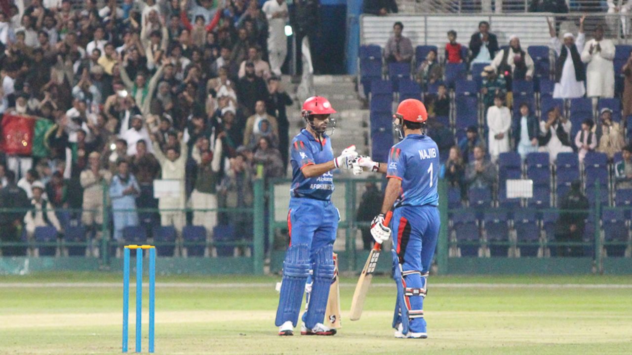 Karim Janat punches gloves with Najibullah Zadran after striking a boundary over midwicket, UAE v Afghanistan, Desert T20, Group A, Abu Dhabi, January 16, 2017