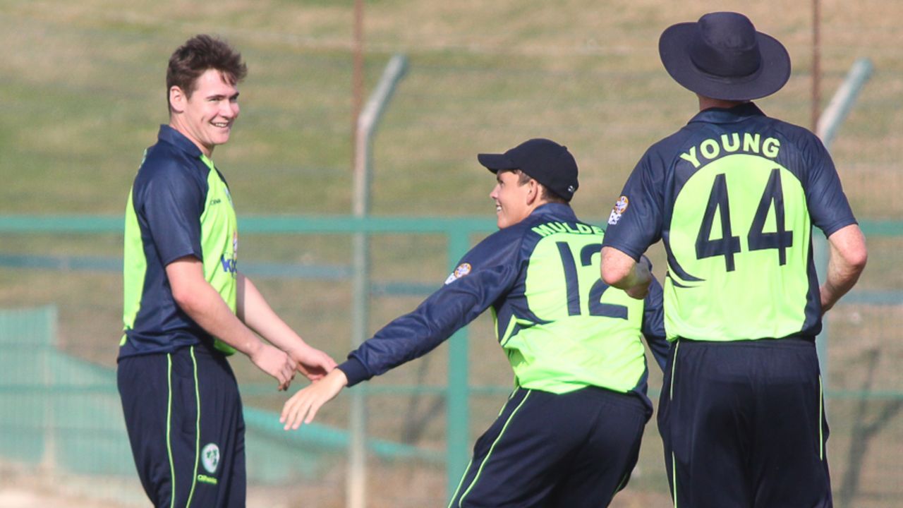 Joshua Little gets congratulated by Jacob Mulder and Craig Young after taking his maiden international wicket, Ireland v Namibia, Desert T20, Group A, Abu Dhabi, January 17, 2017