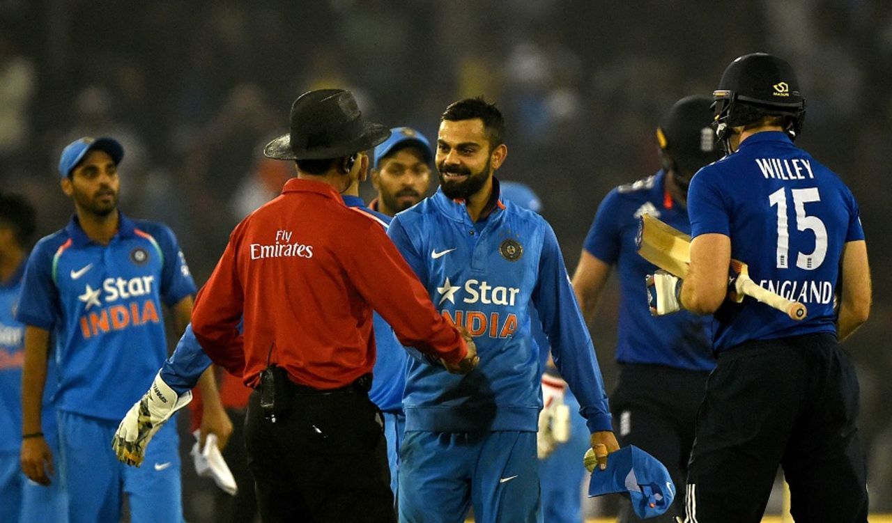 Virat Kohli is congratulated by the umpire after India sealed the match, India v England, 2nd ODI, Cuttack, January 19, 2017