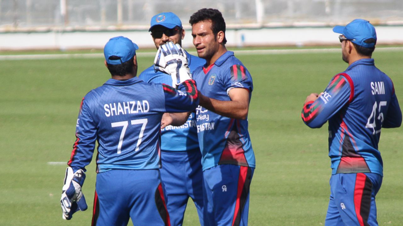 Fareed Ahmad gets a high five from Mohammad Shahzad after taking the first wicket, Afghanistan v Oman, Desert T20, 1st semi-final, Dubai, January 20, 2017