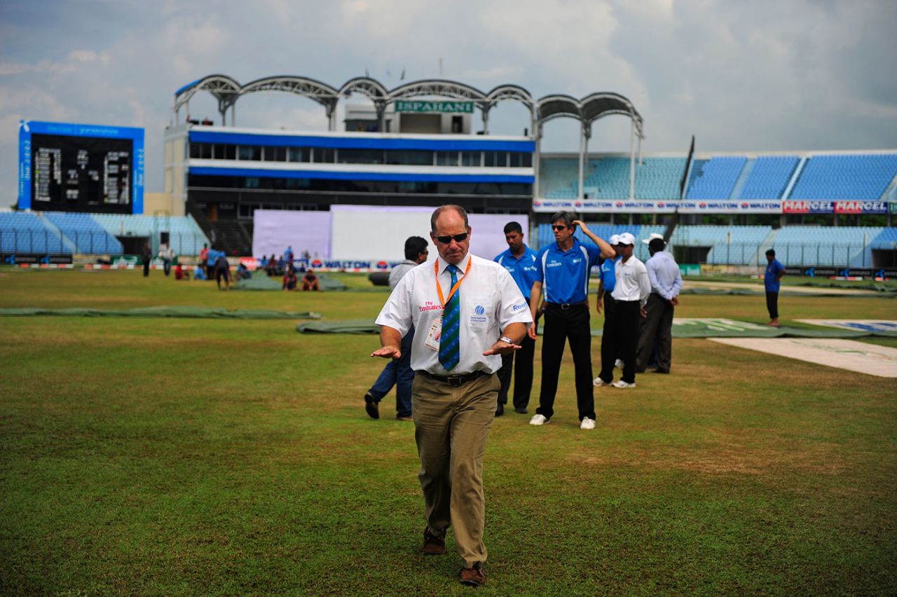 Match referee Andy Pycroft leaves the ground after inspecting the outfield,
Bangladesh v West Indies, first Test, day three, Chittagong, October 23, 2011