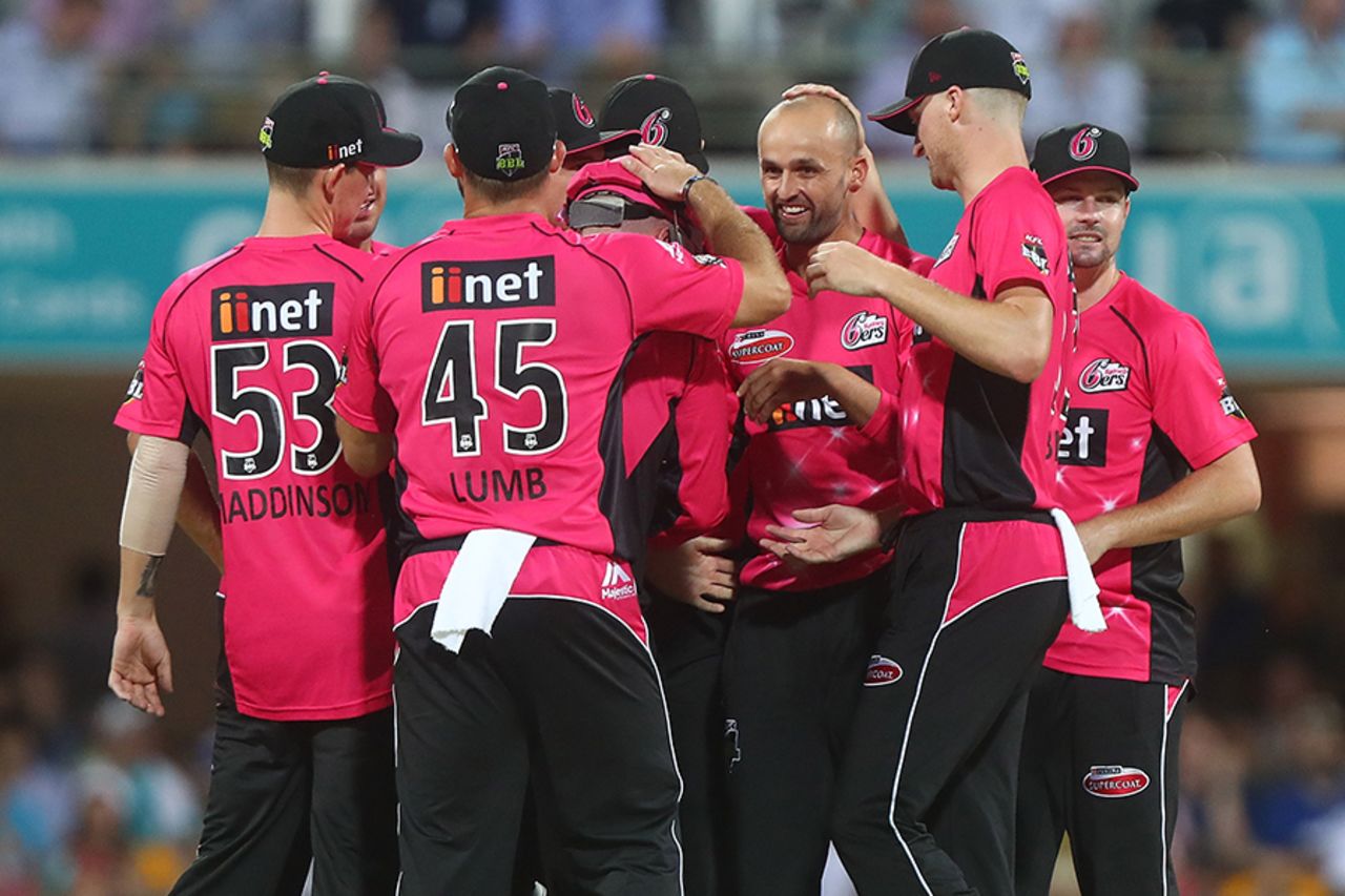 Nathan Lyon is mobbed by team-mates after taking a wicket, Brisbane Heat v Sydney Sixers, Big Bash League 2016-17, semi-final, Brisbane, January 25, 2017