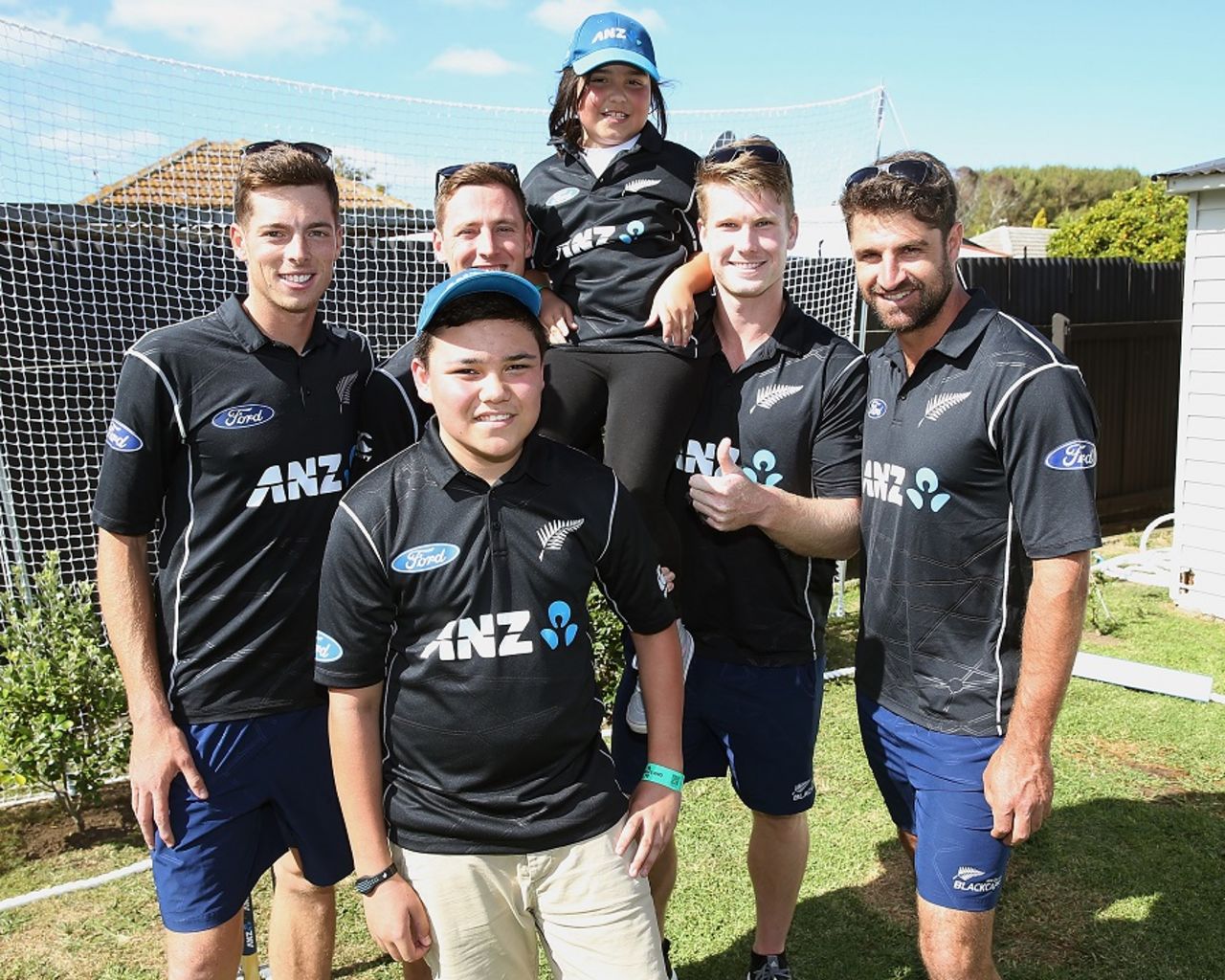 Mitchell Santner, Matt Henry, James Neesham, Colin de Grandhomme pose with kids at an ANZ event, Auckland, January 27, 2017