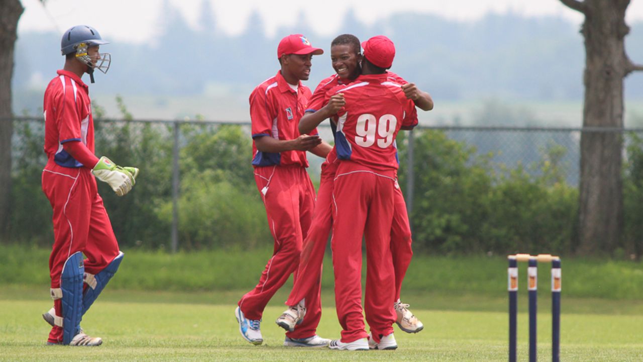 Delray Rawlins gets hugged by Kamau Leverock after completing his five-wicket haul, Bermuda v USA, ICC Americas Under-19 Championship, Division 1, King City, July 8, 2013