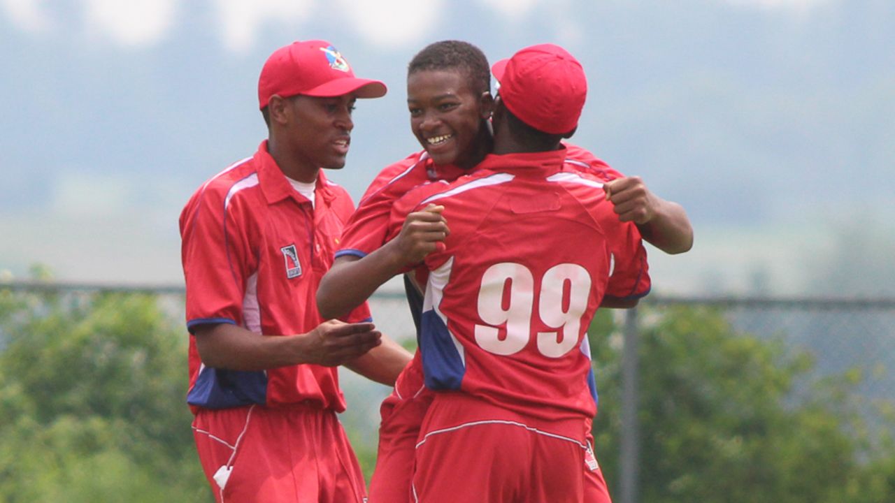 Delray Rawlins gets picked up by Kamau Leverock and patted by Josh Gilbert after his fifth wicket, Bermuda v USA, ICC Americas Under-19 Championship, Division 1, King City, July 8, 2013