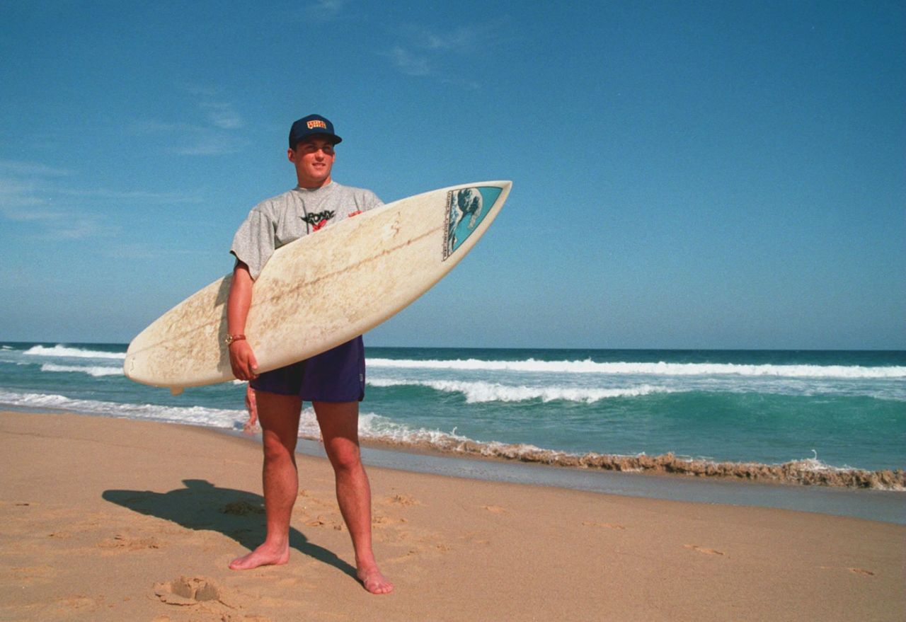 Darren Gough poses with a surfboard in Newcastle, November 10, 1994