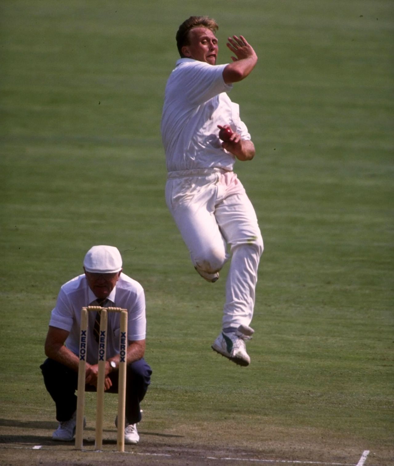 Fast bowler Brett Schultz bowls, watched by umpire Cyril Mitchley, South Africa Board President's XI v Indians, Centurion Park, November 7, 1992