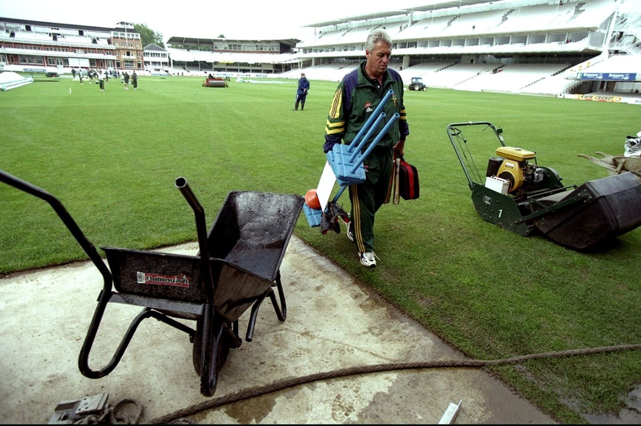 Bob Woolmer walks past construction equipment for a training session, Lord's, June 16, 1998