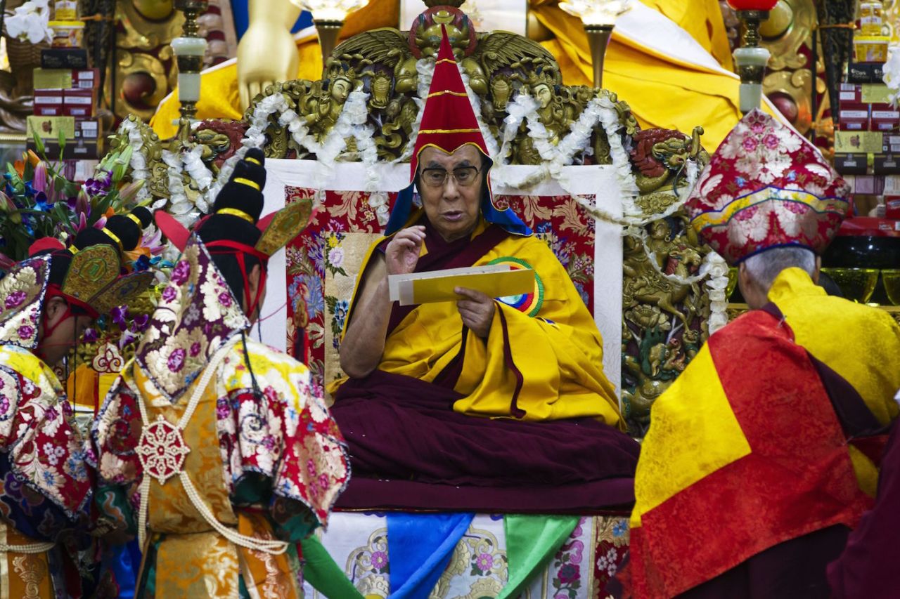 His Holiness, the Dalai Lama wears the red hat during the long life prayer at Tsugla Khang Temple in Mcleodganj, Dharamshala on November 2, 2016.