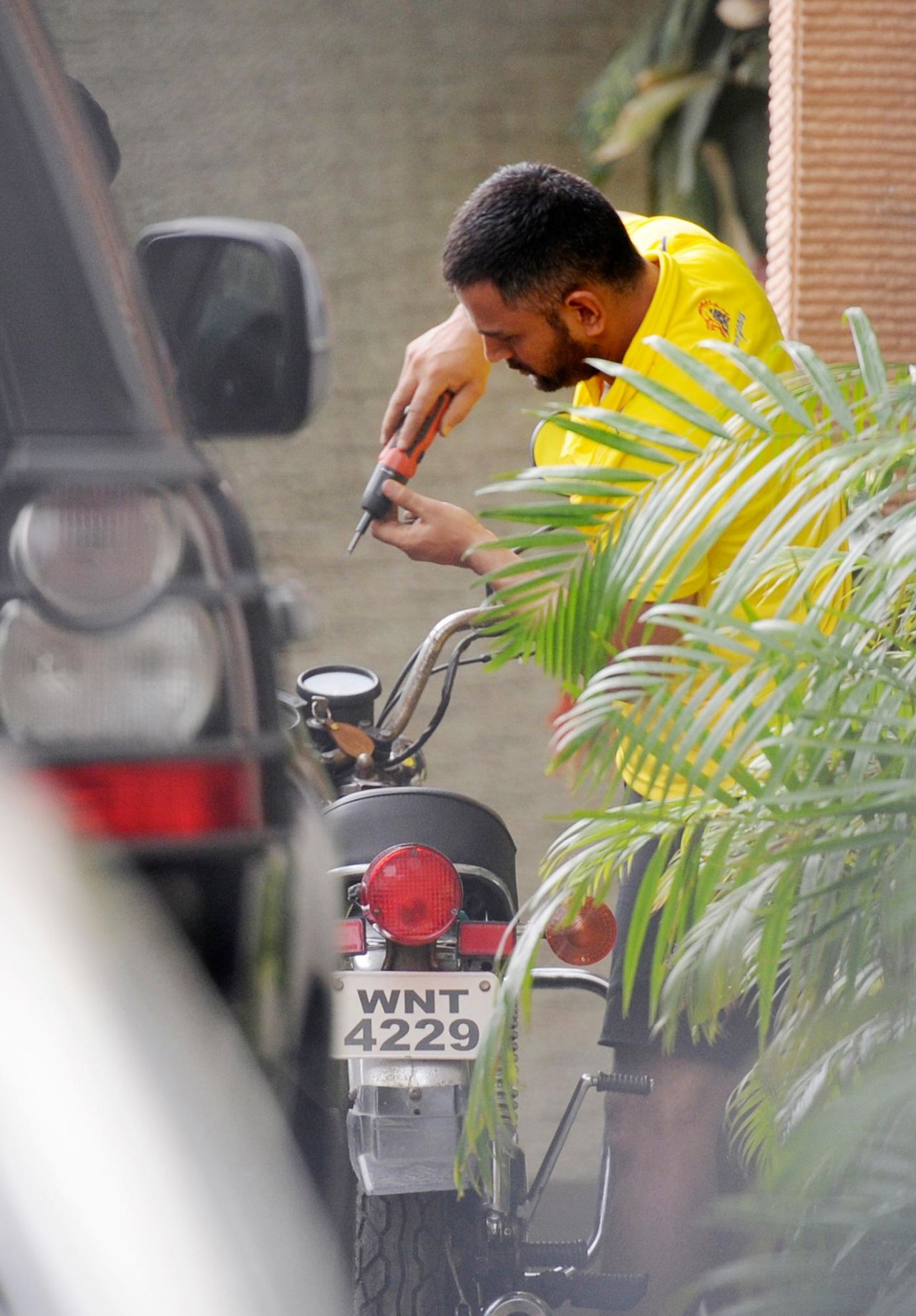 MS Dhoni tends to his motorcycle outside his house, Ranchi, July 7, 2015