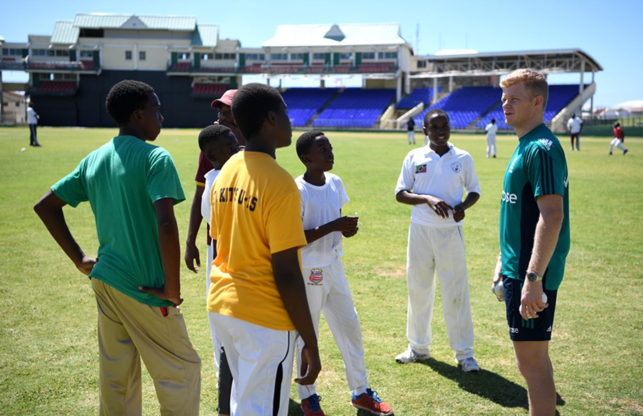 Sam Billings chats with young cricketers during a training session at Warner Park, St Kitts, February 23, 2017