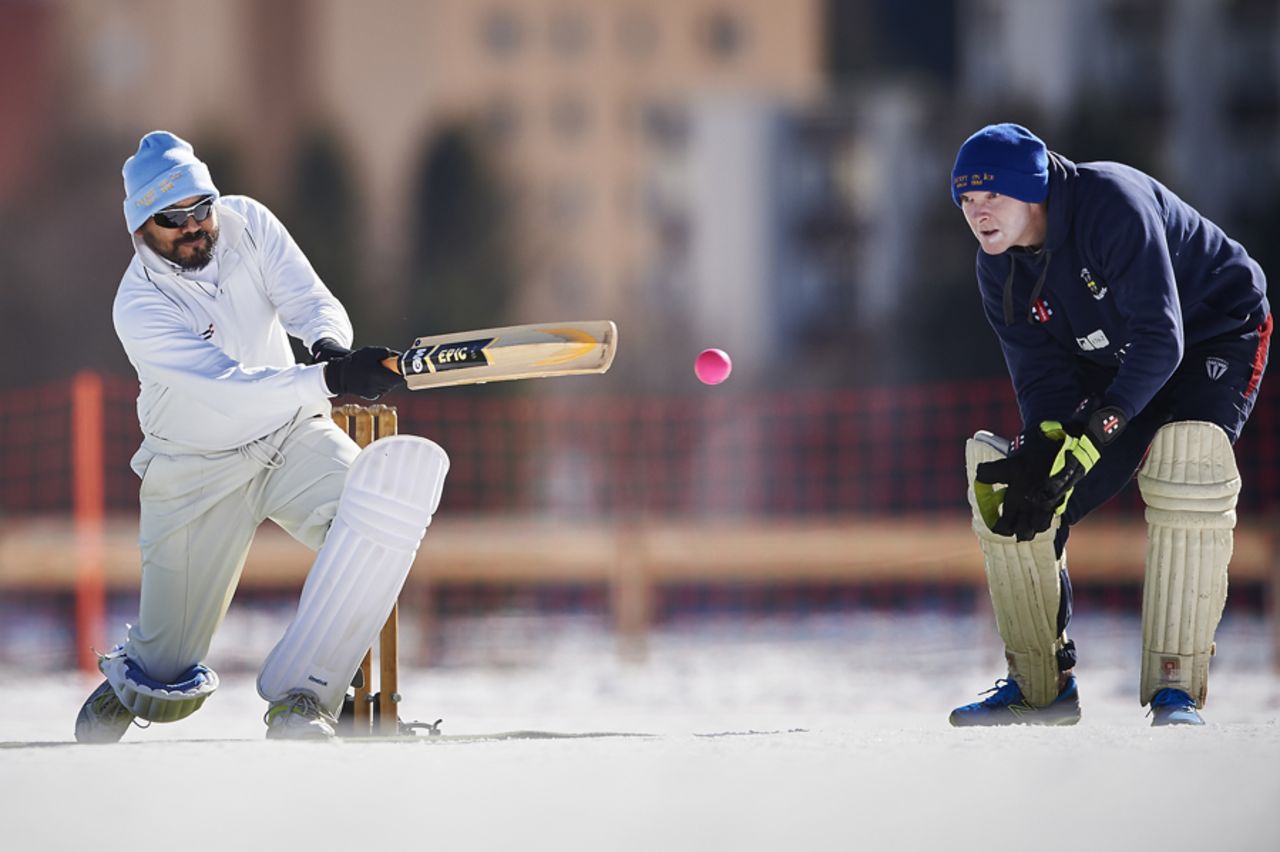 A player bunts the ball away during  the 30th Cricket on Ice tournament held on the frozen Lake St. Moritz, Switzerland February 25, 2017