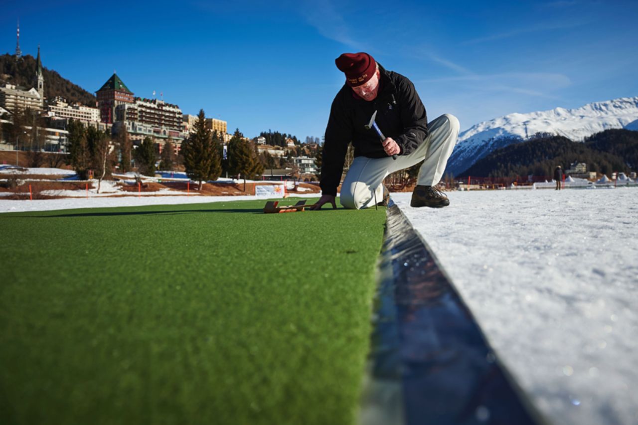 A man prepares the pitch for the 30th Cricket on Ice tournament held on the frozen surface of Lake St. Moritz, Switzerland, February 25, 2017