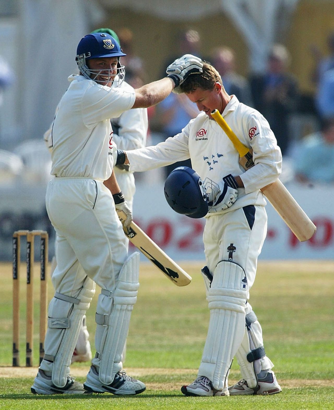 Chris Adams congratulates Murray Goodwin on hitting the title-sealing four, Sussex v Leicestershire, County Championship Division One, Hove, 2nd day, September 18, 2003