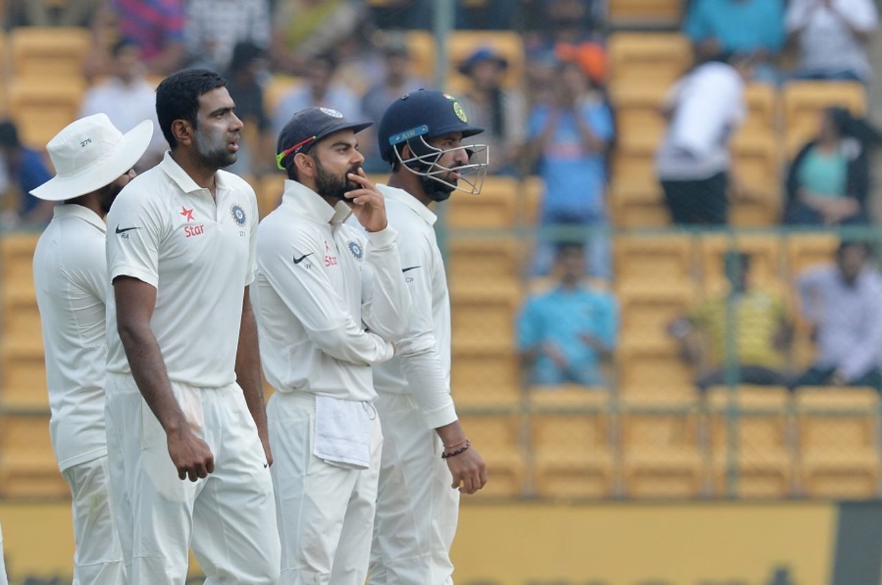 R Ashwin, Virat Kohli and Cheteshwar Pujara wait on a DRS review, India v Australia, 2nd Test, Bengaluru, 2nd day, March 5, 2017
