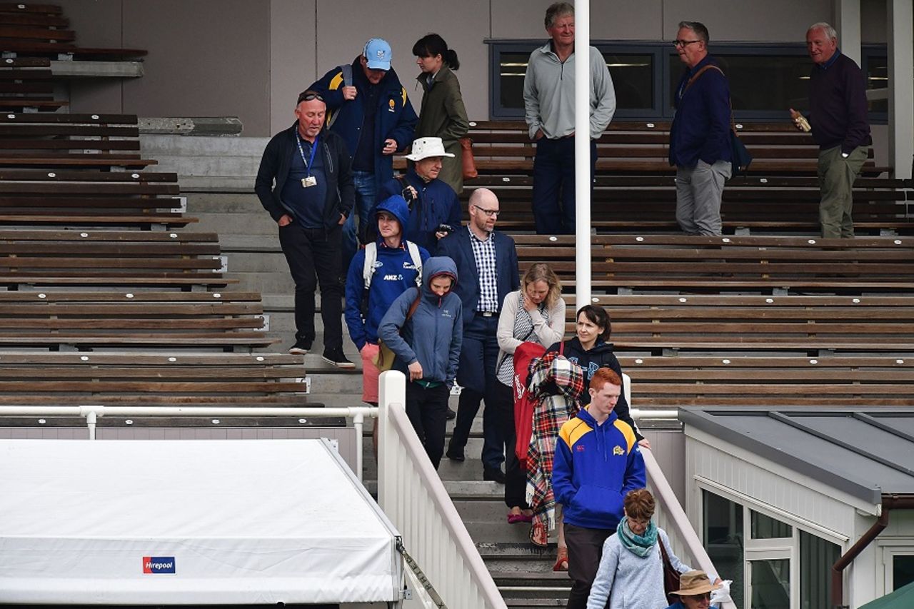 Fans evacuate from the main stand after a fire alarm, New Zealand v South Africa, 1st Test, Dunedin, 3rd day, March 10, 2017