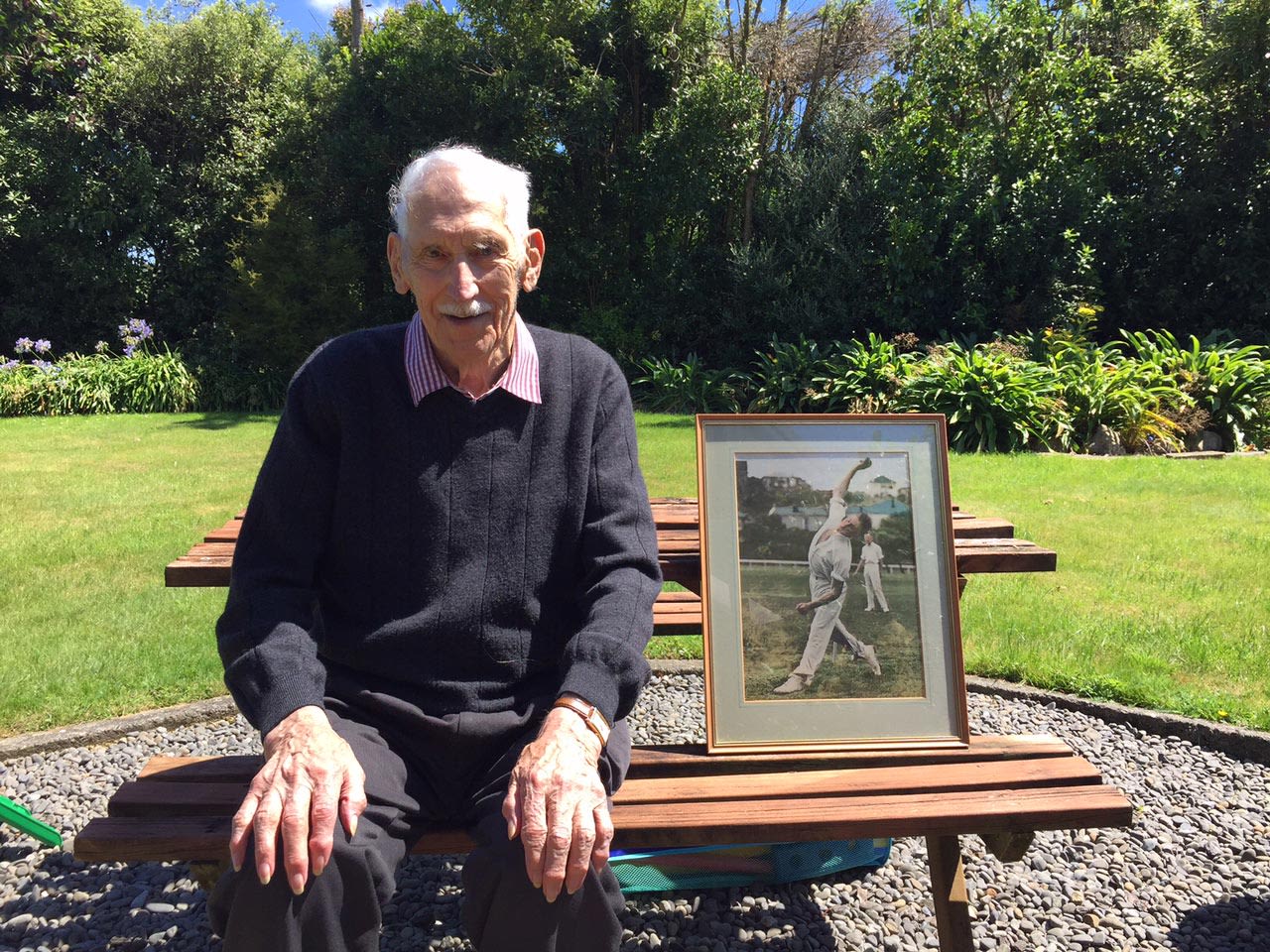 Tom Pritchard with photograph of himself in his bowling stride, March 2017