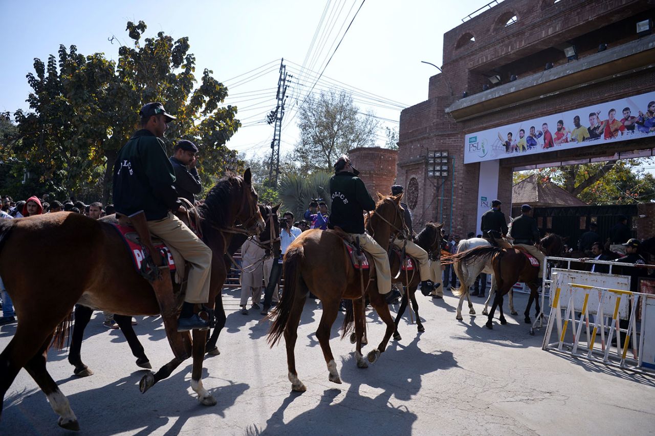Pakistani policemen patrol on horses as spectators queue at an entry gate of the Gaddafi Stadium in Lahore, March 5, 2017