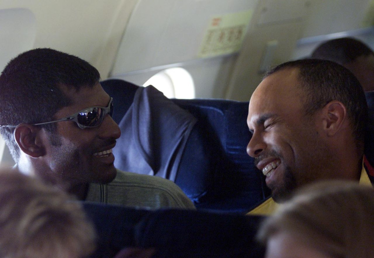 Mahendra Nagamootoo and Jimmy Adams share a laugh on a flight