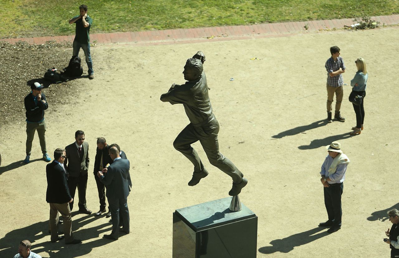 Spectators make their way past the statue of Shane Warne, Australia v India, third Test, day one, Melbourne, December 26, 2014