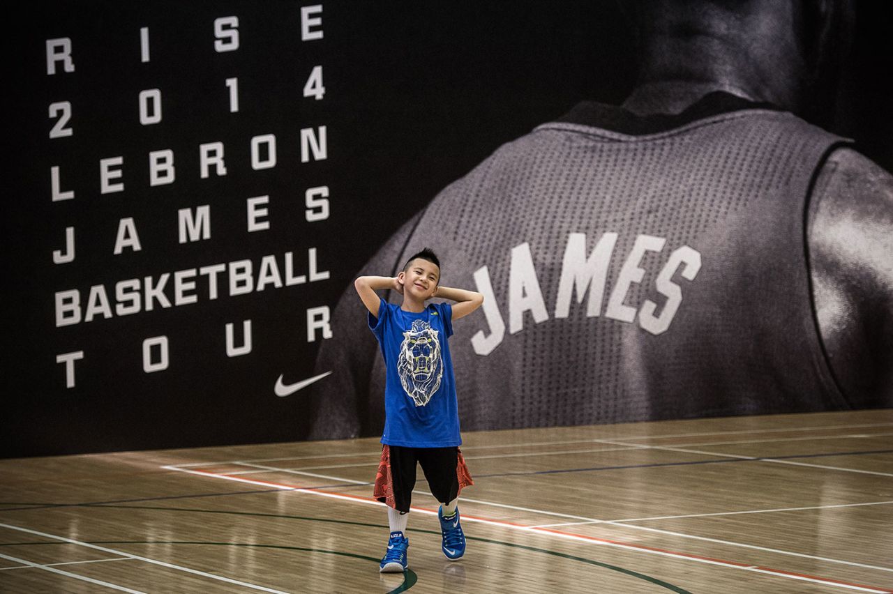 A kid waits to meet LeBron James at a promotional event in Hong Kong, July 23, 2014