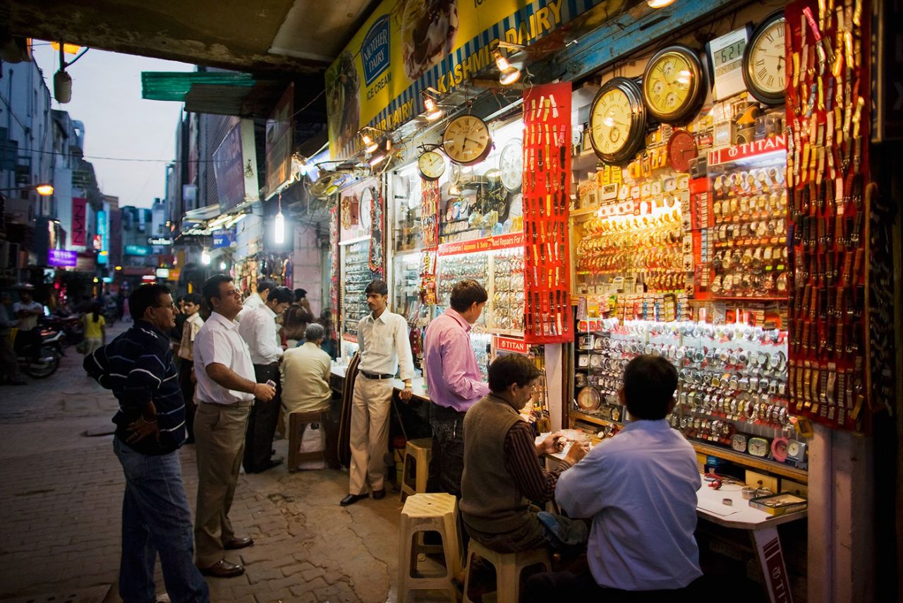 Shoppers look at watches in an alley in Khan Market, February 24, 2009