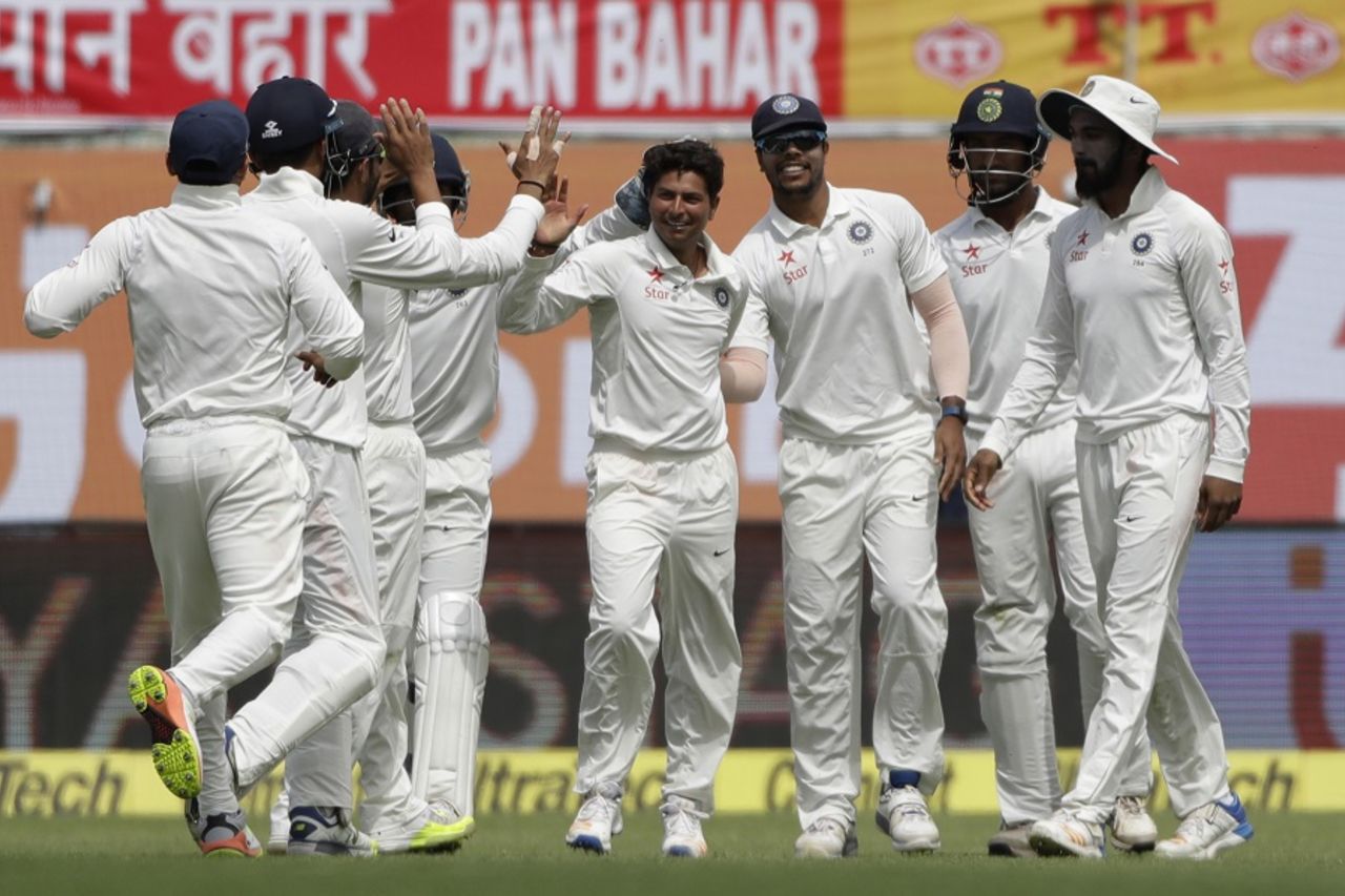 Kuldeep Yadav is mobbed by his team-mates, India v Australia, 4th Test, Dharamsala, 1st day, March 25, 2017