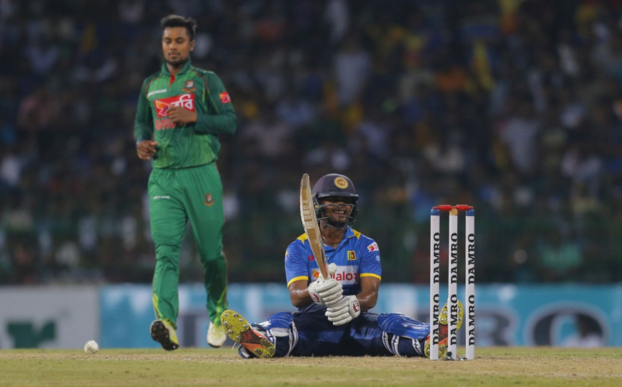 Asela Gunaratne wears a grin after landing awkwardly, Sri Lanka v Bangladesh, 1st T20I, Colombo, April 4, 2017