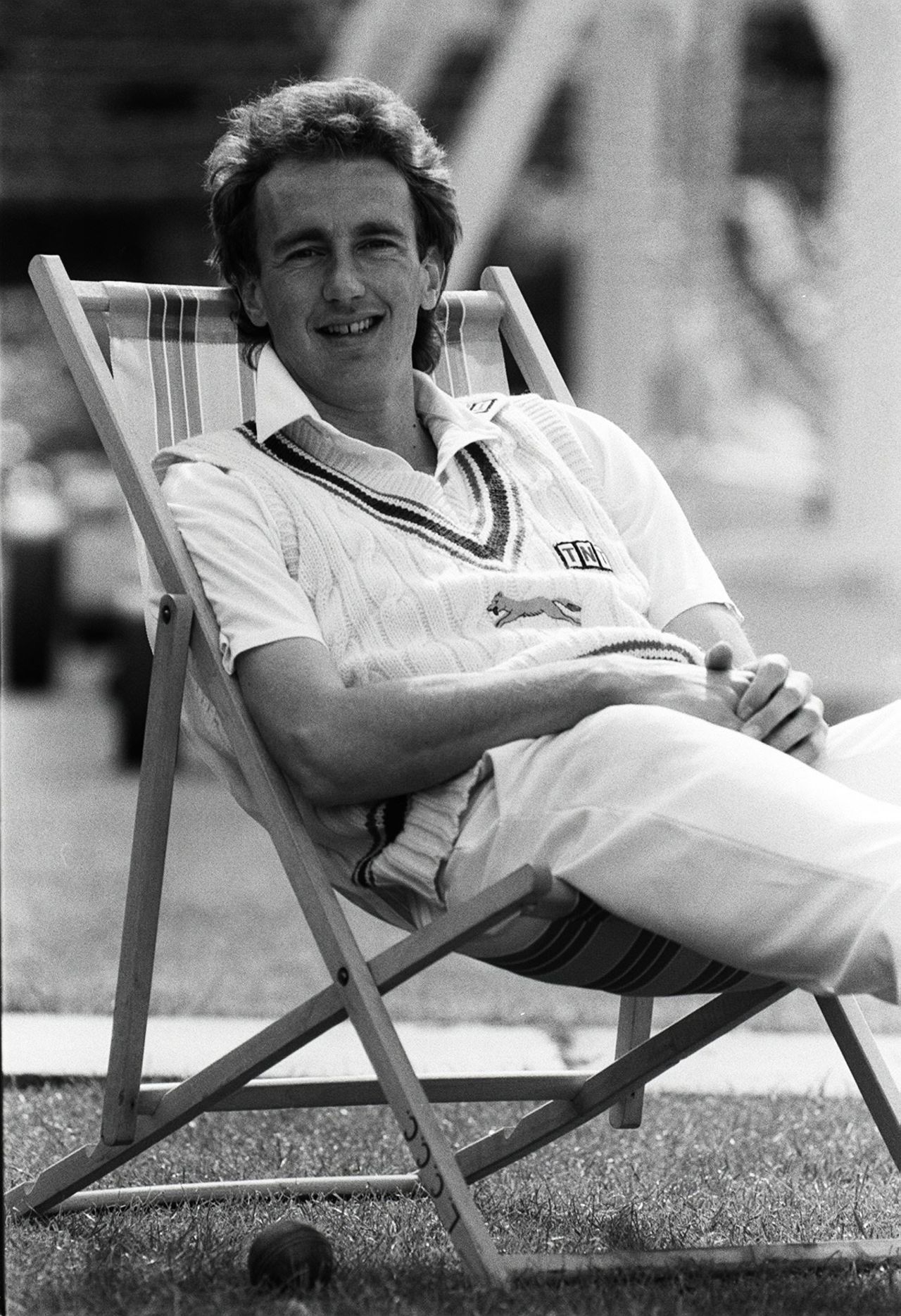 Jonathan Agnew reclines in a folding chair, May 19, 1988