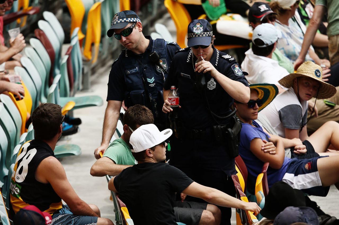 A security official smells a bottle to check for alcohol, Australia v New Zealand, 1st Test, Brisbane, 2nd day, November 6, 2015