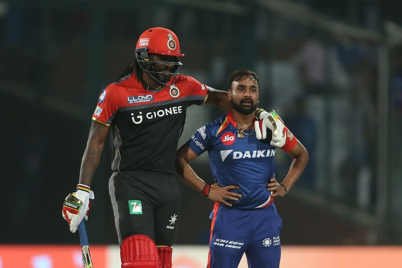 The long and short of it: Chris Gayle consoles Amit Mishra after an lbw appeal was turned down, Delhi Daredevils v Royal Challengers Bangalore, IPL 2017, Delhi, May 14, 2017