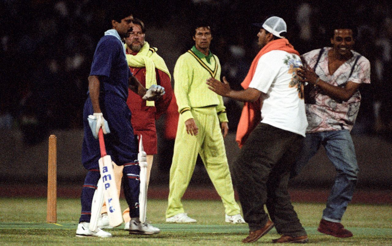 A fan invades the pitch during an India-Pakistan charity match. Kapil Dev and Imran Khan look on, Crystal Palace, July 29, 1992