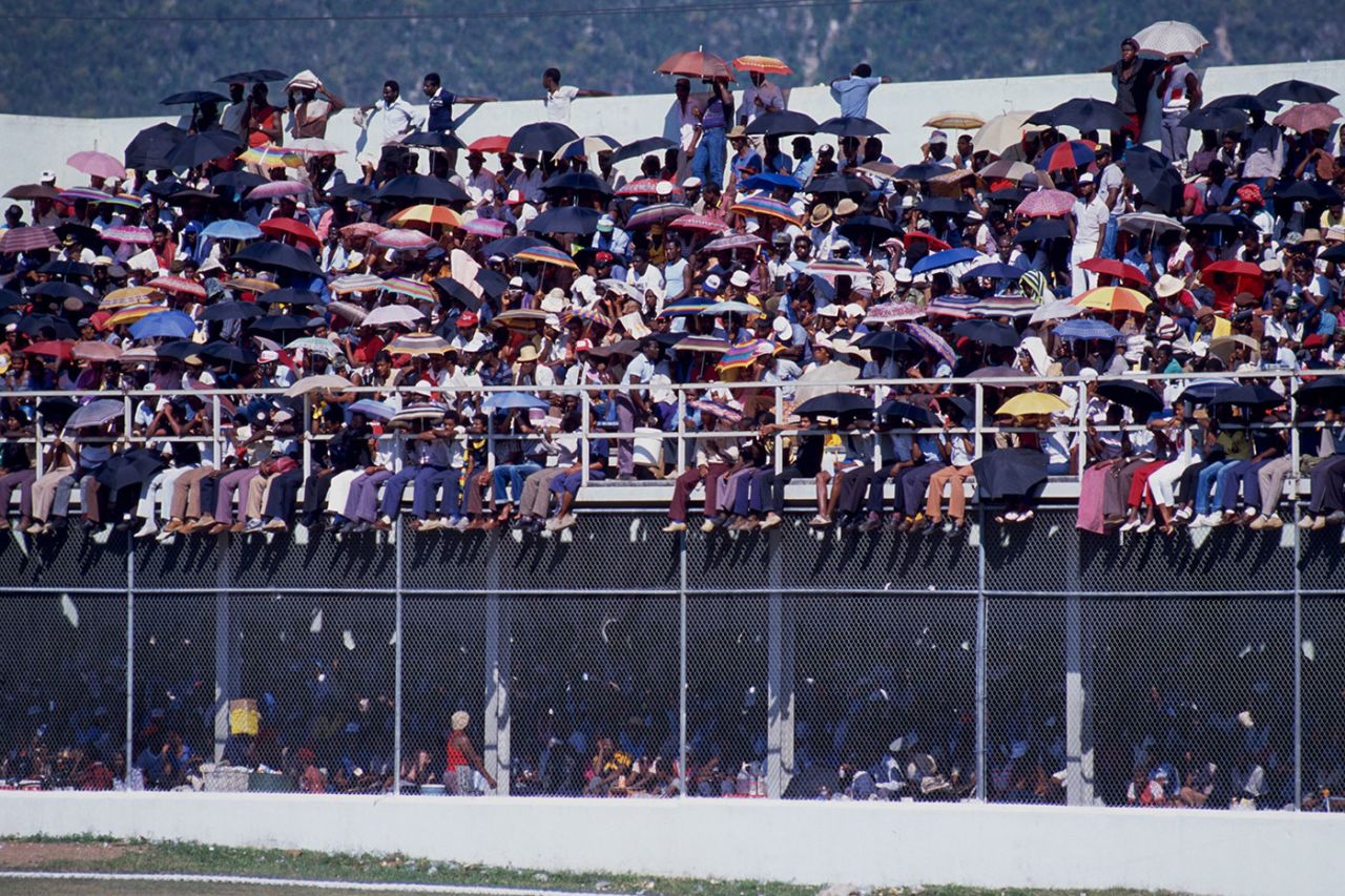 Spectators use umbrellas to shield themselves from the sun, West Indies v England, 1st Test, Kingston, February 1986